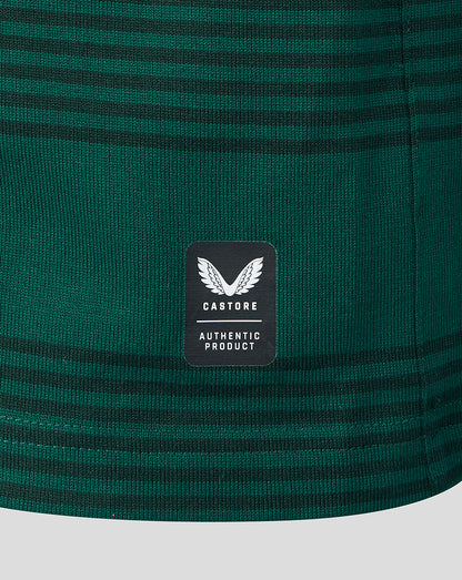 Close-up of a dark green striped knit fabric with a black Castore brand patch on the front.