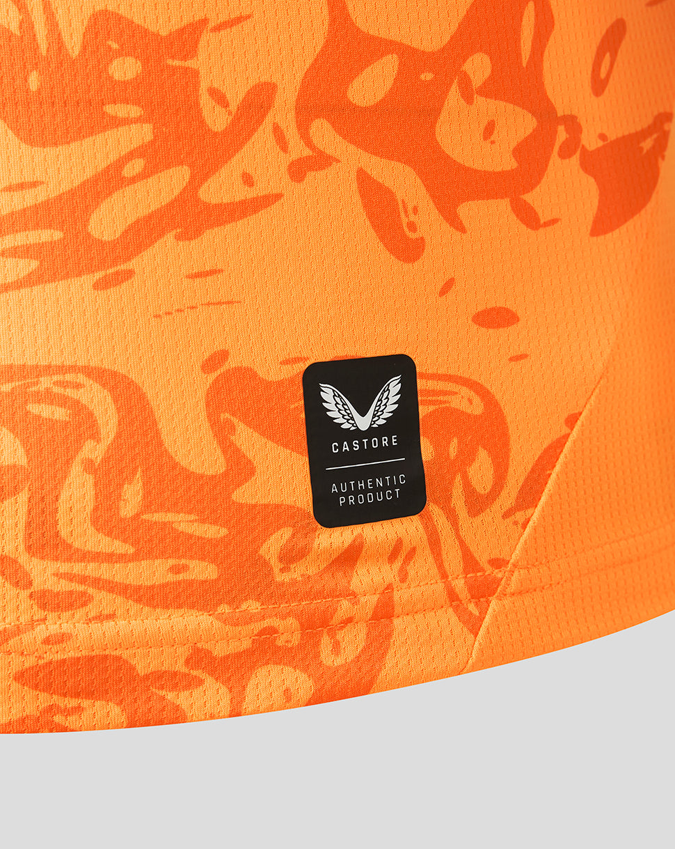 Detail of FC Twente orange goalkeeper shirt fabric featuring an authenticity patch and bold pattern