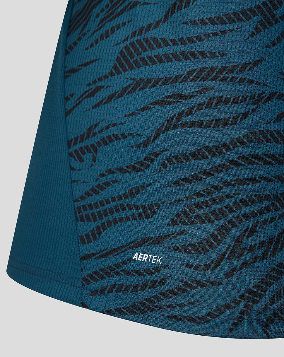 Close-up of teal FC Utrecht away shirt fabric with black tiger stripe pattern and AERTEK label near the hem.