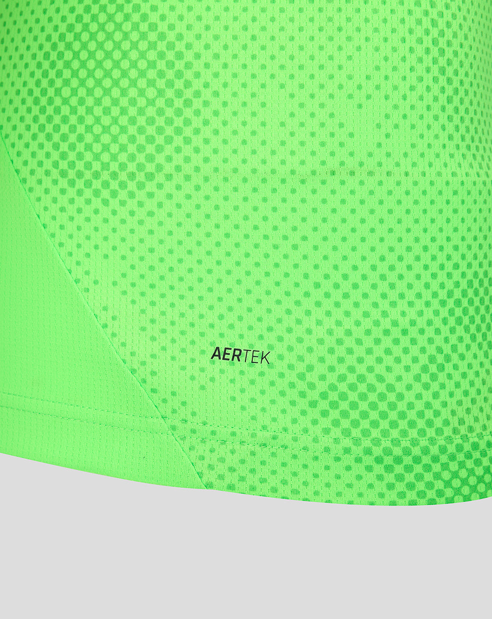 Close up of neon green goalkeeper shirt fabric with dot pattern and AERTEK branding