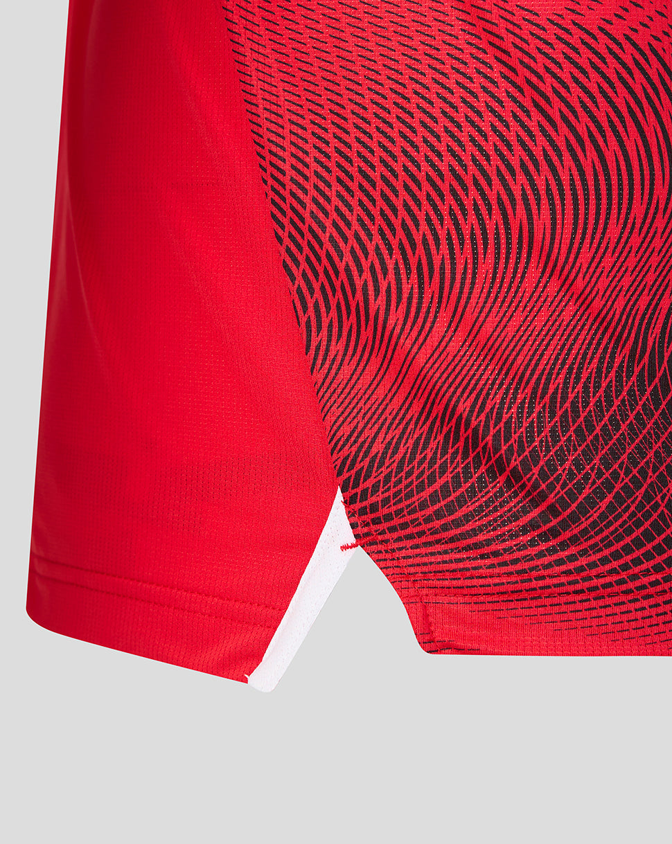Detail of FC Utrecht shirt showing red fabric with black swirling pattern along the side