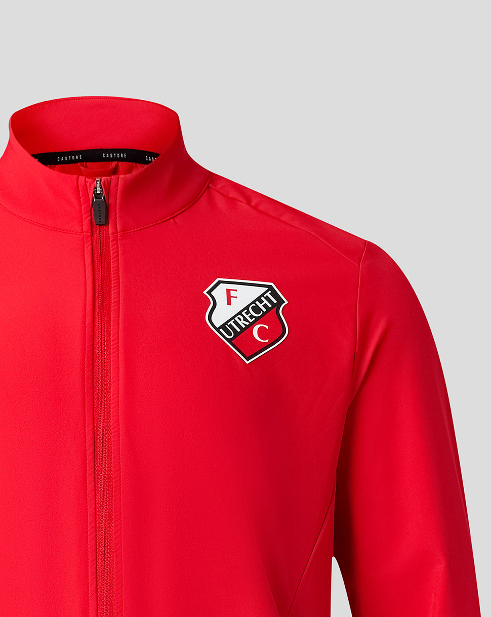 Close-up of the red jacket showing the FC Utrecht crest at the chest beside the center zipper