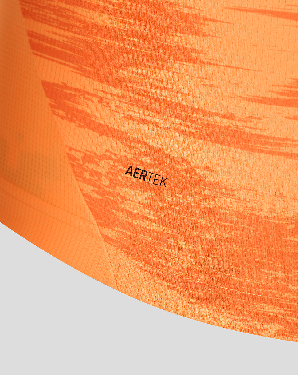 Close-up of orange jersey fabric with AERTEK label