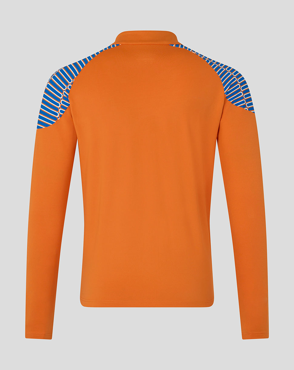 An orange long-sleeve athletic top shown from the back, featuring blue and white diagonal striped panels on the shoulders, set against a solid gray background.