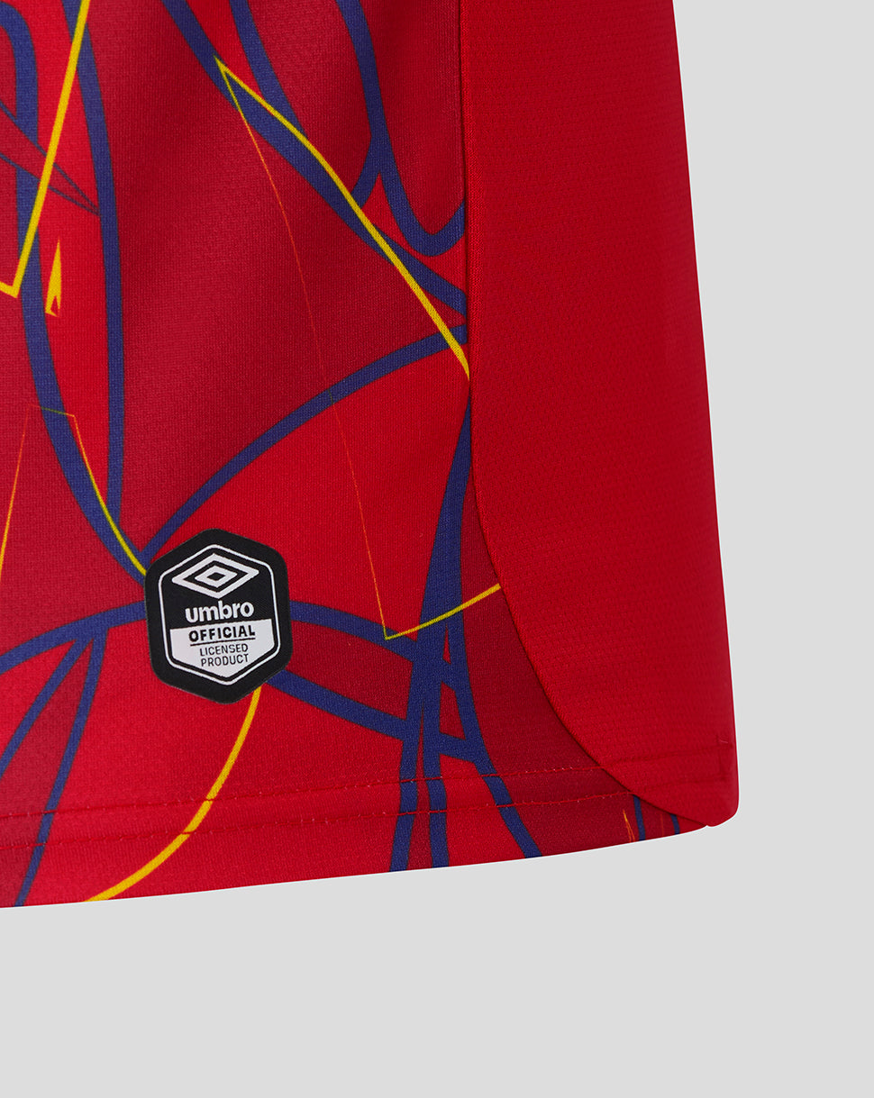 Red shorts with blue and yellow abstract design and Umbro logo on a light gray background