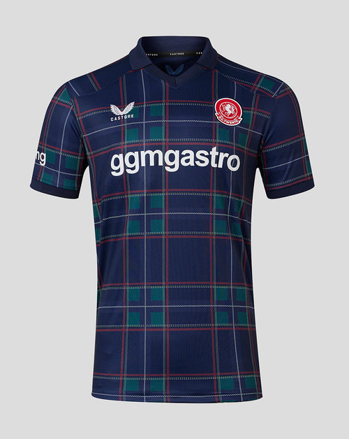 A short-sleeve football jersey by Castore, featuring a navy blue base with a green and red tartan plaid pattern. The jersey has a white 'gmgastro' sponsor logo across the chest, a red and white club crest on the right chest, and a white Castore logo on the left chest, set against a solid light gray background.