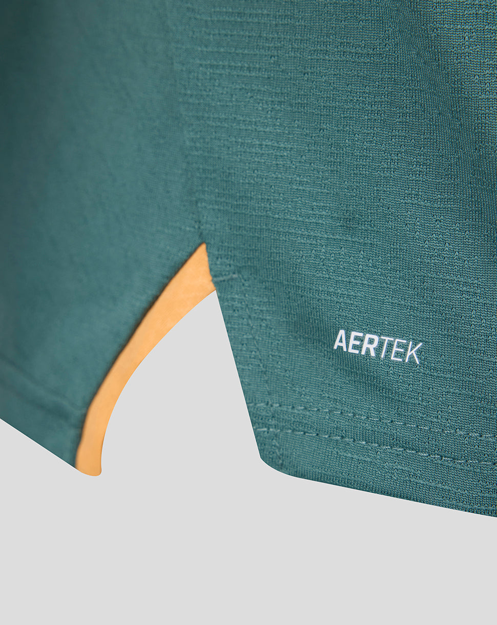Close up of teal fabric with AERTEK branding and an orange curved accent panel