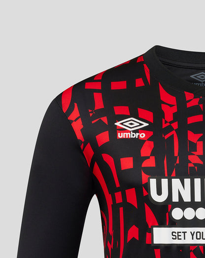 Black and red sports jersey with Umbro logo on a gray background