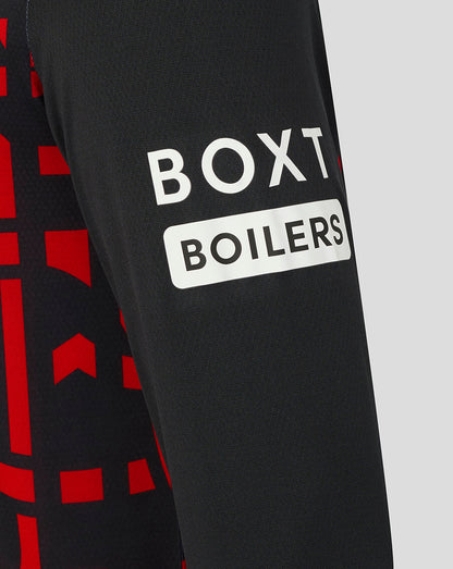 Close-up of a black sleeve with 'BOXT BOILERS' logo on a red and black patterned background.