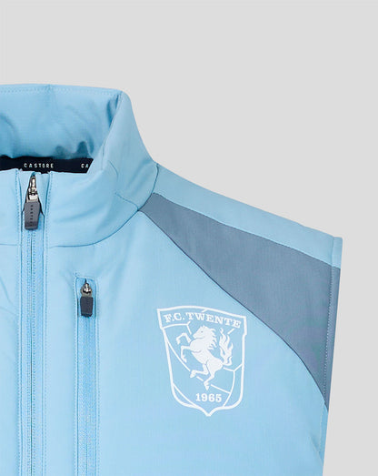 Light blue FC Twente training gilet with front zipper and club crest on the chest.