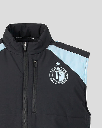 Front close up of black coach gilet with high collar, central zipper, chest zip pocket, Feyenoord crest and light blue shoulder panel