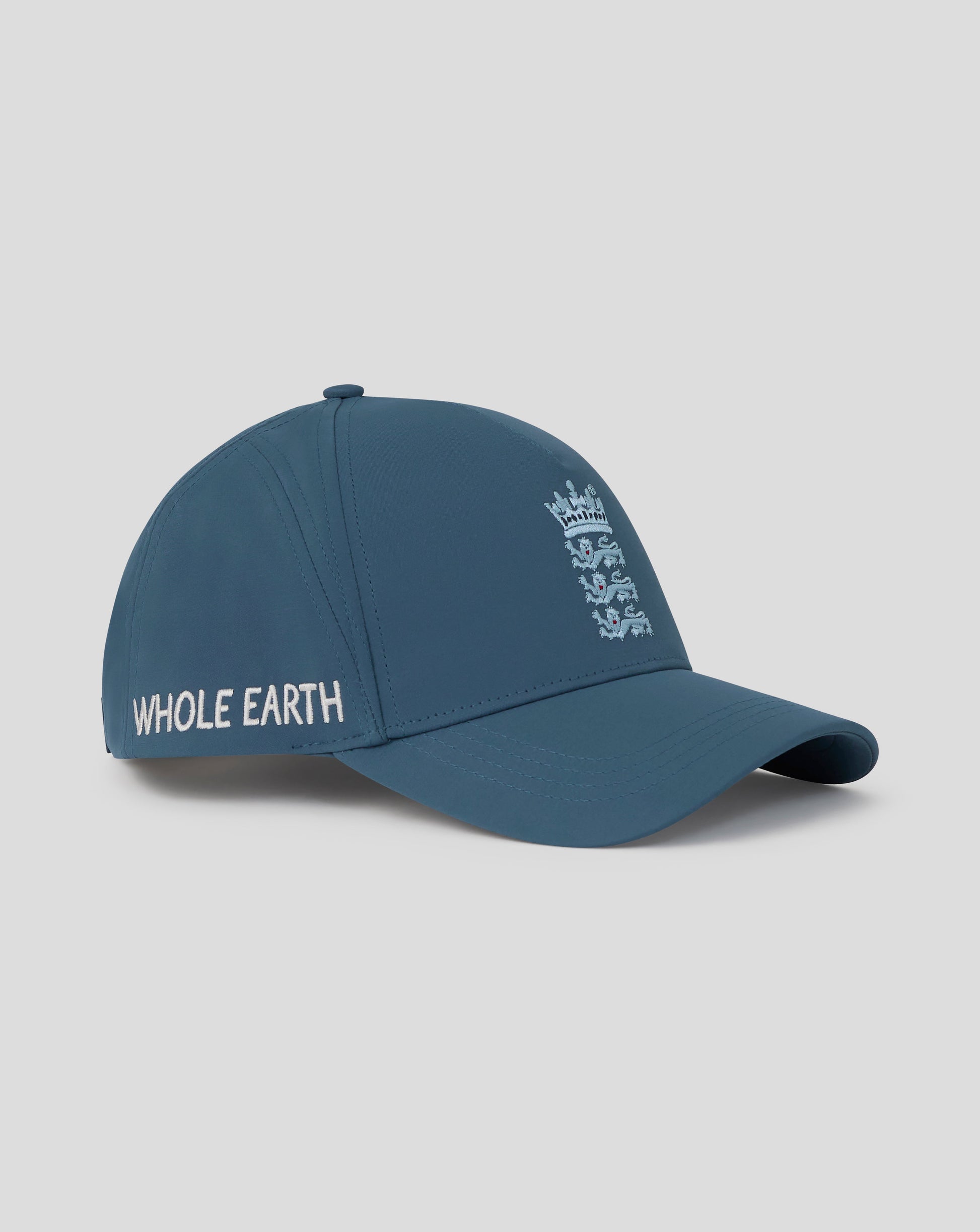 Blue cap with 'Whole Earth' logo on a gray background