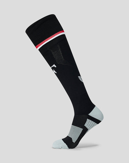 Feyenoord Junior home sock in black with a red and white cuff, featuring a white Feyenoord F on the shin and a Castore logo on the calf.