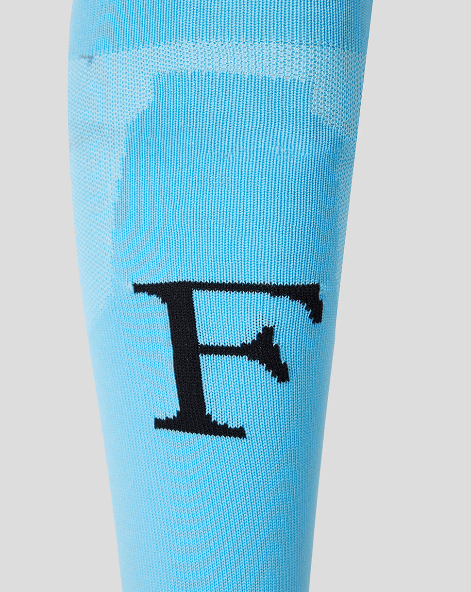 Close up of the Feyenoord F emblem on a light blue away sock