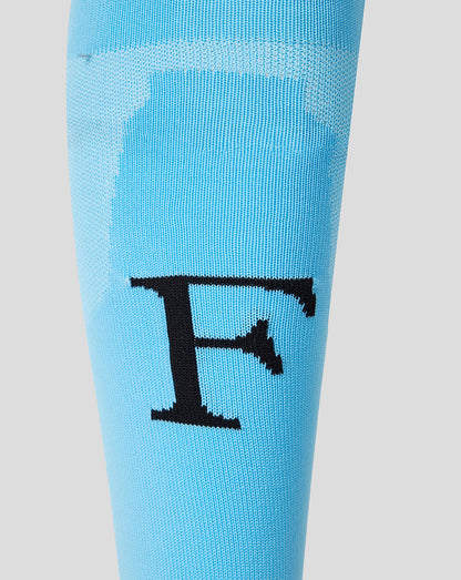 Close up of the Feyenoord F emblem on a light blue away sock