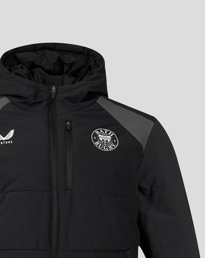 A close-up of a black hooded puffer jacket with a front zipper, featuring a circular 'BATH Rugby' logo on the left chest and a white winged logo on the right chest, set against a light gray background.