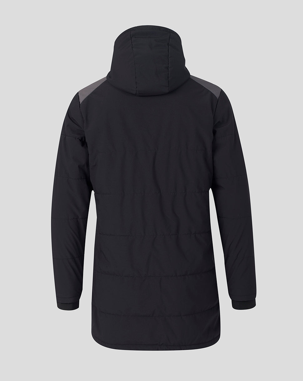 A black hooded puffer jacket shown from the back, featuring dark gray shoulder panels, on a solid light gray background.