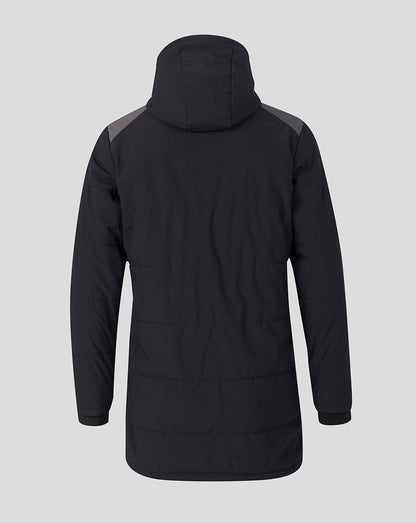 A black hooded puffer jacket shown from the back, featuring dark gray shoulder panels, on a solid light gray background.