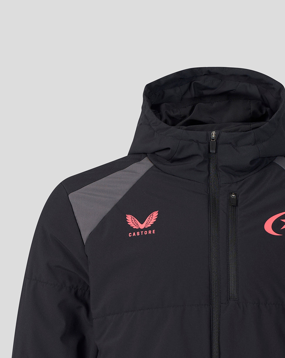 A close-up of a black hooded jacket with gray shoulder panels, featuring a pink Castore wing logo on the left chest and a partial pink logo on the right chest, set against a light gray background.