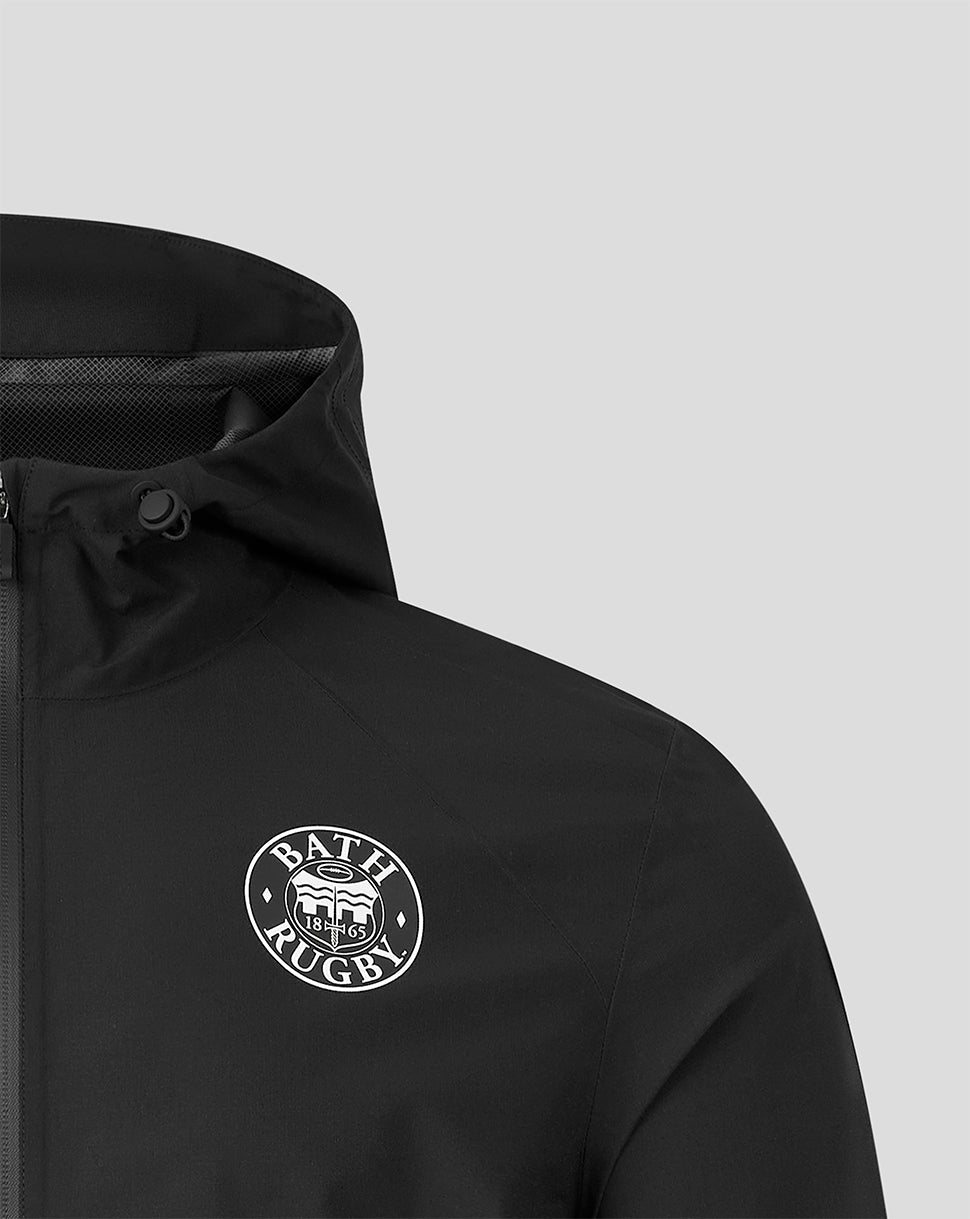 Close-up of a black hooded jacket with a white circular Bath Rugby logo on the chest, shown against a light gray background.