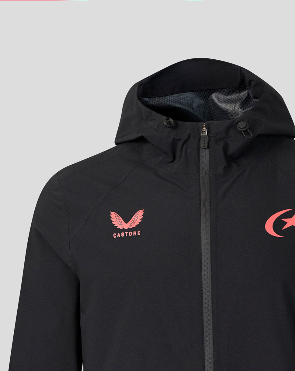 A close-up of a black hooded jacket featuring a pink winged logo with the word 'CASTORE' on the left chest and a pink crescent logo on the right chest, set against a solid light gray background.
