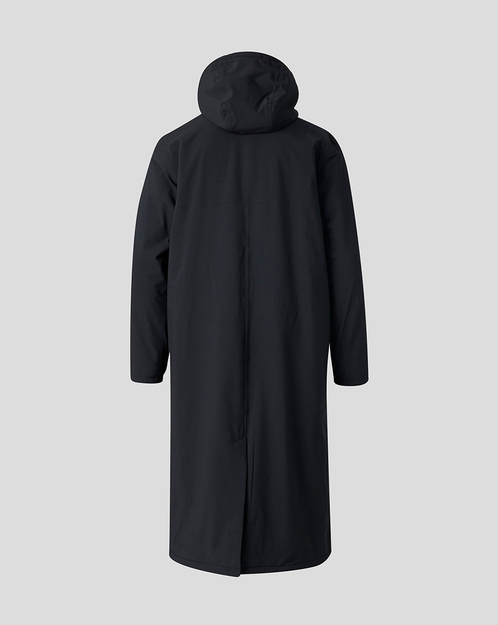 A long black hooded coat shown from the back, displayed on a headless mannequin against a solid light gray background.