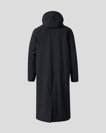 A long black hooded coat shown from the back, displayed on a headless mannequin against a solid light gray background.
