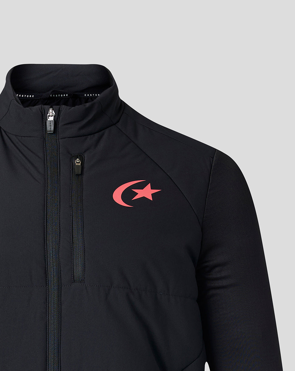 A close-up of a black athletic jacket featuring a red crescent and star logo on the left chest, set against a solid light gray background.