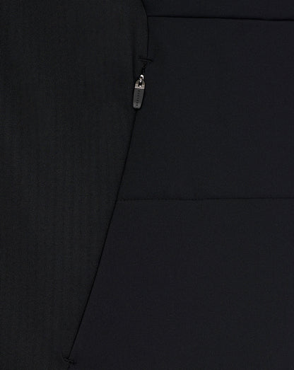 Close-up of a black jacket with a zipper detail on a plain background
