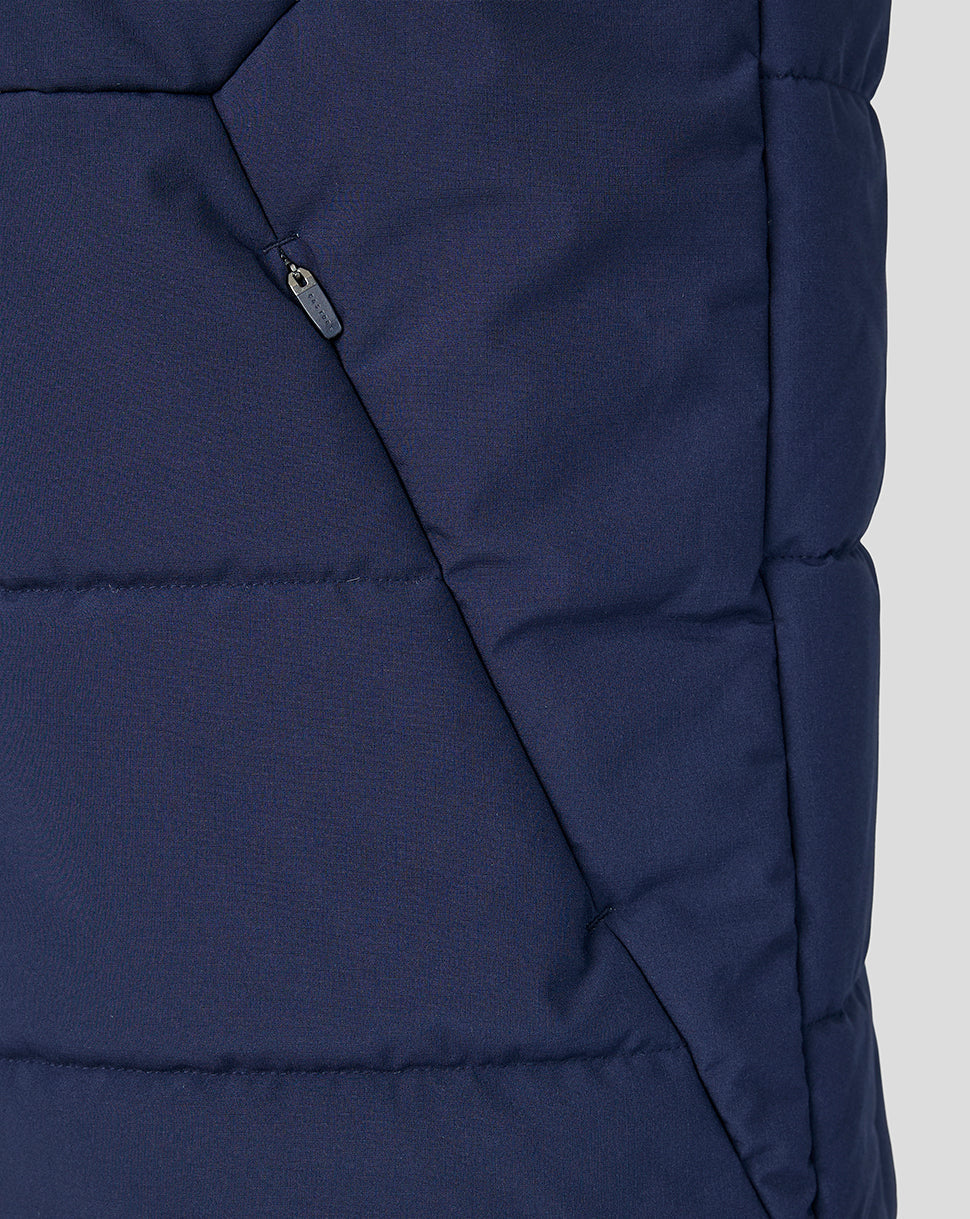Close-up of a blue puffer jacket on a light gray background