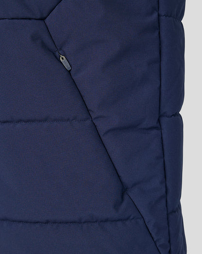 Close-up of a blue puffer jacket on a light gray background