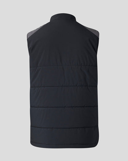 A black sleeveless puffer vest shown from the back, featuring horizontal quilting and contrasting dark gray shoulder panels, set against a solid light gray background.