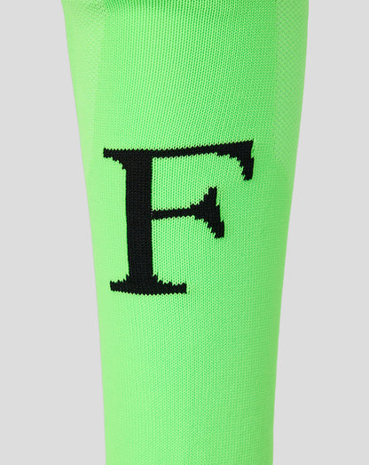Neon green Feyenoord 2026-2027 home goalkeeper sock close up with black F emblem at the shin