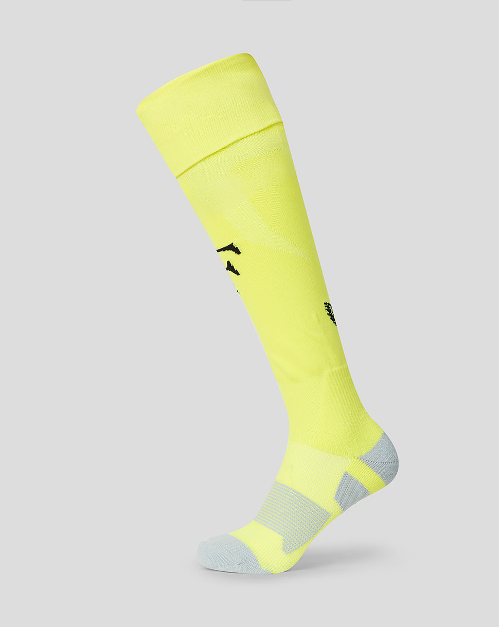 Neon yellow Feyenoord Junior Away goalkeeper sock with reinforced heel and footbed Castore logo at calf and Feyenoord F on the shin