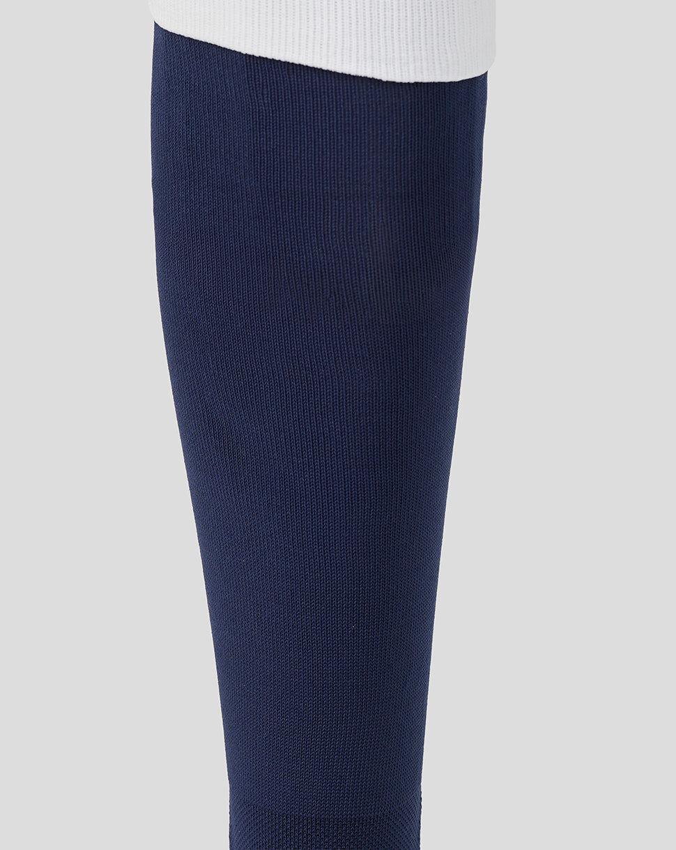 Navy blue compression sock on a light gray background