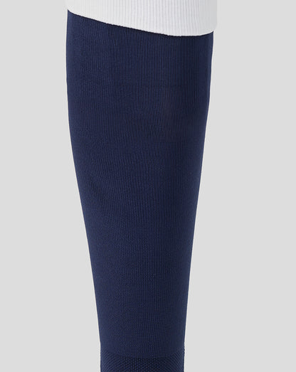 Navy blue compression sock on a light gray background