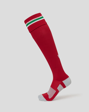 A single red knee-high athletic sock with green and white stripes at the cuff and light gray toe and heel sections, shown on a light gray background.