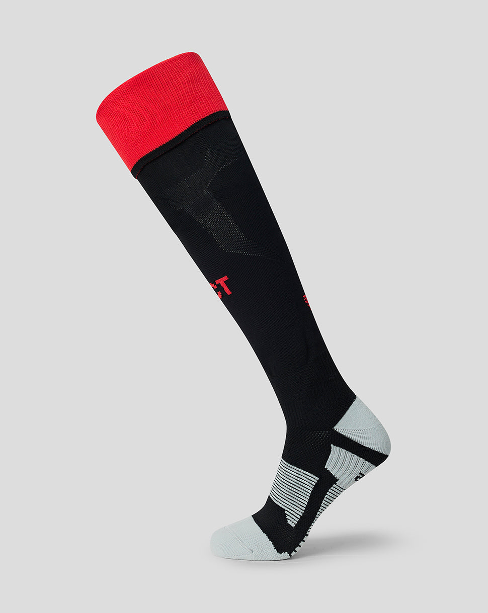 FC Twente away sock in black with a red top cuff and light gray heel and toe displayed on a neutral background.
