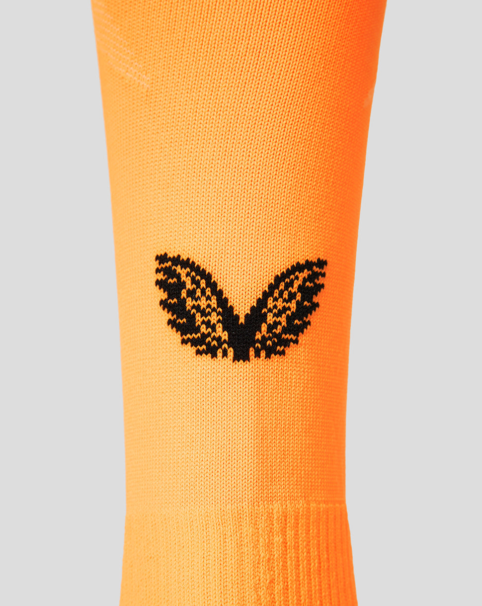 Close up of orange FC Twente goalkeeper sock with a black wing logo