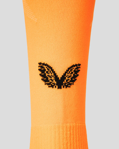 Close up of orange FC Twente goalkeeper sock with a black wing logo