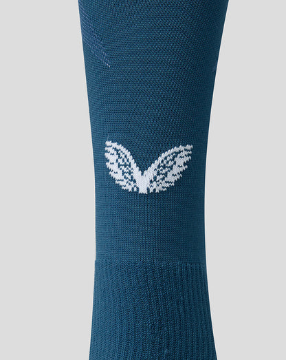 Calf level close up showing the white leaf emblem on teal FC Utrecht Away sock