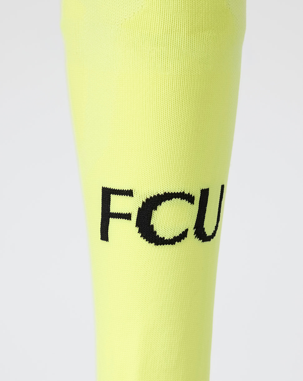 Close-up of neon yellow FC Utrecht Away Goalkeeper Sock shin with FCU branding.