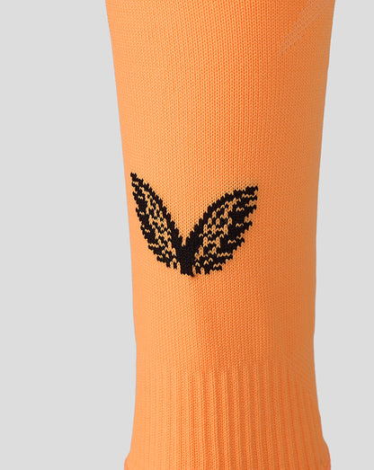 Orange Athletic Club footless sock with a black winged logo on the leg area