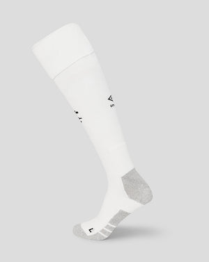 White knee-high sock with a small logo on a light gray background