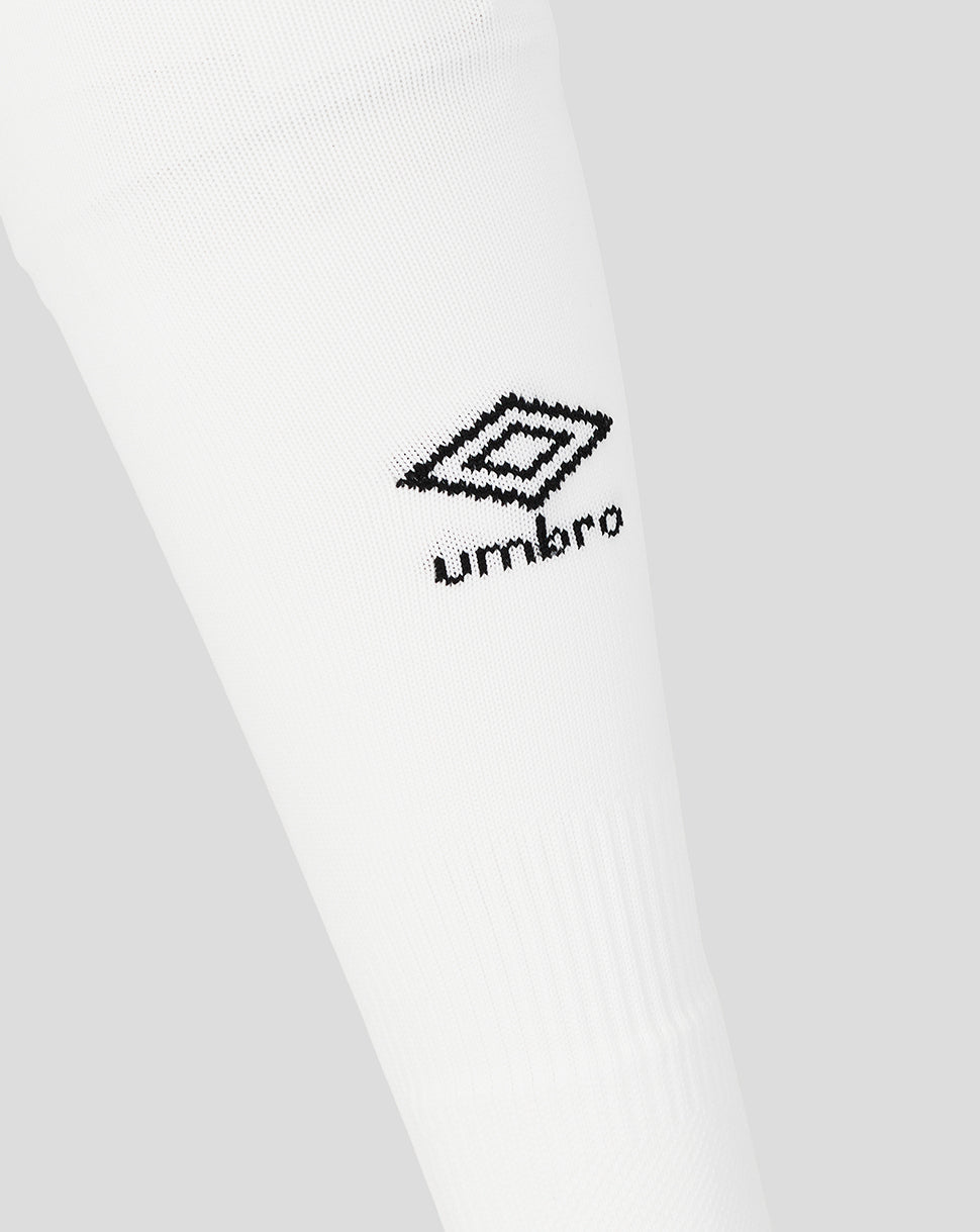 Close-up of white socks with a black Umbro logo on a light gray background