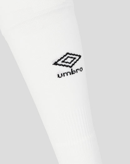 Close-up of white socks with a black Umbro logo on a light gray background