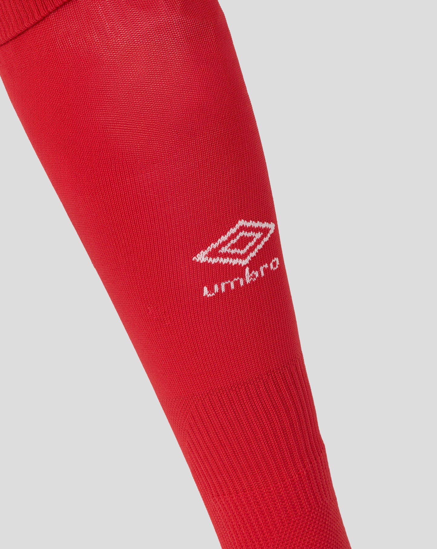 Red sock with Umbro logo on a light gray background