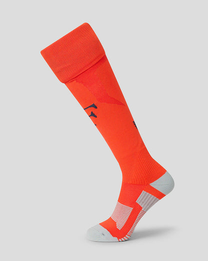 Full view of orange Feyenoord 2026-2027 third sock on a leg with navy F on the shin and a gray heel and toe