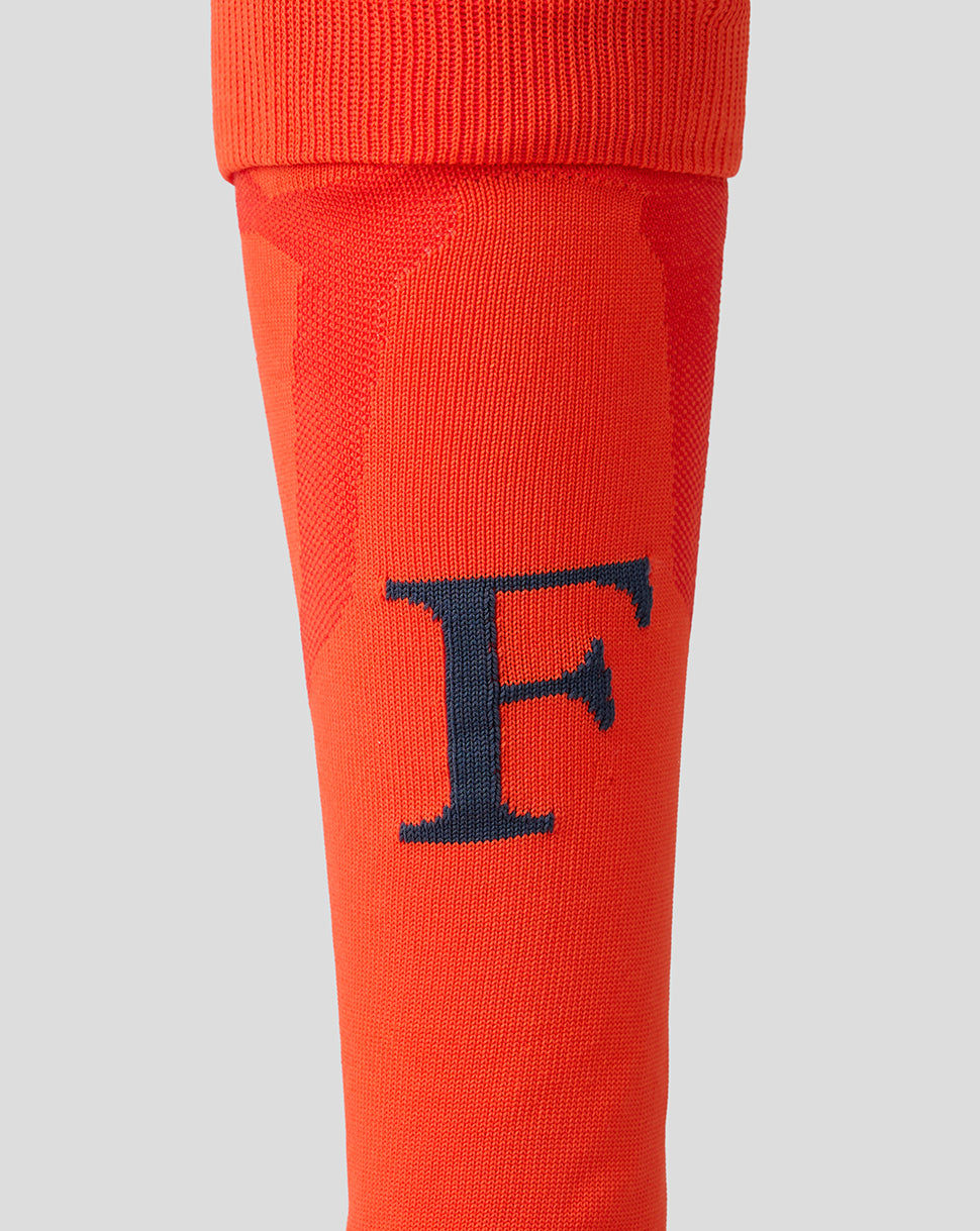 Close-up of orange Feyenoord 2026-2027 third sock featuring navy F on the shin and reinforced gray heel area