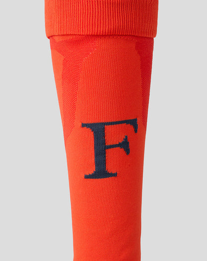 Close-up of orange Feyenoord 2026-2027 third sock featuring navy F on the shin and reinforced gray heel area